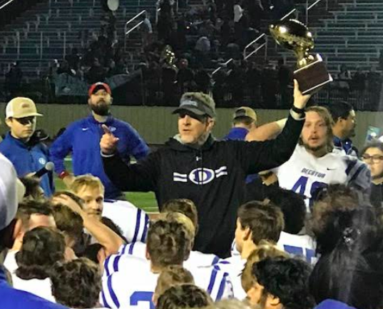 Photo courtesy of Carrie Alano
Pictured: Coach Mike Fuller giving a talk to his team after victory against Hirschi