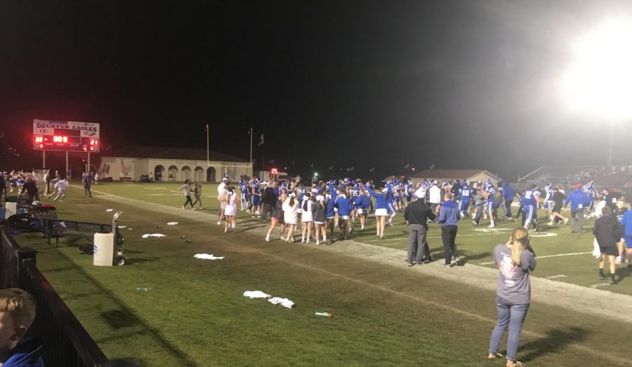 Fans fill the field after the Eagles upset victory over the top ten ranked Huskies last season. Photo Credit: Carrie Alano