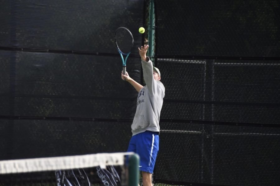 A+Decatur+tennis+player+prepares+to+serve+the+ball+at+their+district+match.